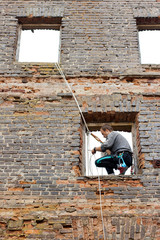 climber on the ruined brick wall