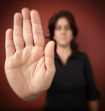 Woman with her hand extended signaling to stop