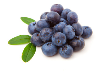 Blueberries with green leaves isolated on white background