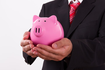 Businessman Holds Piggy Bank