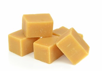 A pile of vanilla fudge on a white background