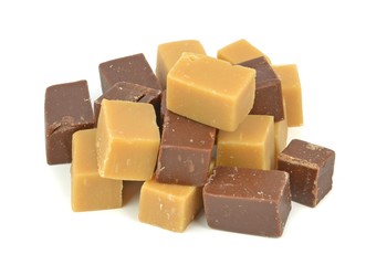 A pile of vanilla and chocolate fudge on a white background
