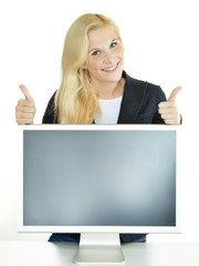 Woman presenting her display with copyspace, shows thumbs up