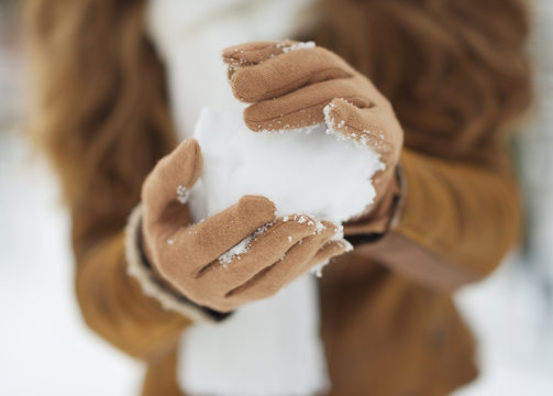 Closeup on snow ball in woman hand