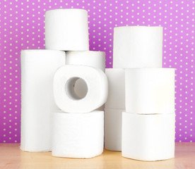 Rolls of toilet paper on purple with dots background