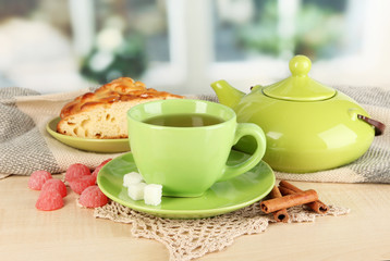 cup of tea with scarf on table in room