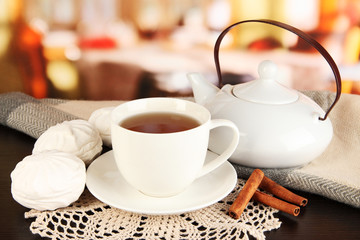 cup of tea with scarf on table in room