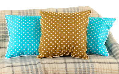 Colorful pillows on couch isolated on white