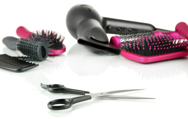 Comb brushes, hairdryer and cutting shears, isolated on white