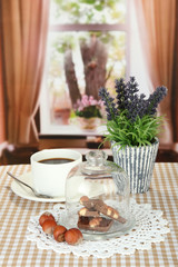 Chocolate pieces under glass cover and hot drink
