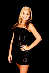 blond woman in little black dress, smiling at the camera