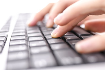 Closeup of  hands typing on computer keyboard