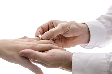 Close up of putting a wedding ring on the finger