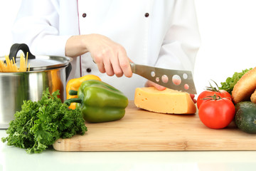 Female hands cutting cheese, isolated on white