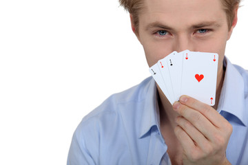 Boy showing poker cards