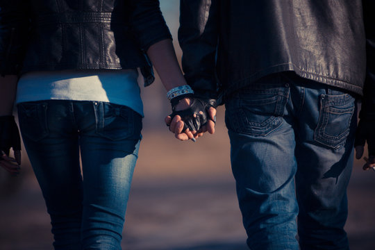 Girl And Guy Are Walking Hand By Hand