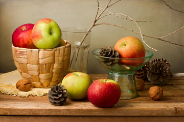 Still life with fresh apples and pine corn on wooden table