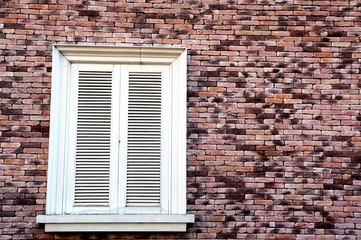 Brick wall with white vintage window