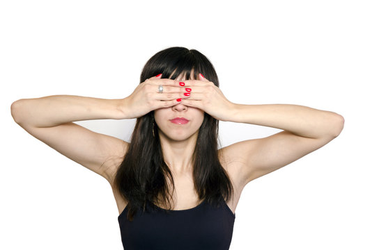 Portrait of young beautiful woman covering her eyes