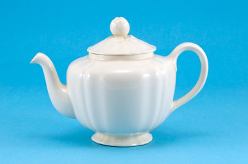 retro ceramic white teapot dish on blue background