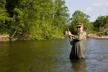Fisherman pulls caught salmon