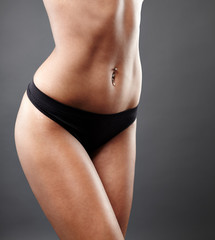 Fototapeta premium Perfect female body on gray background