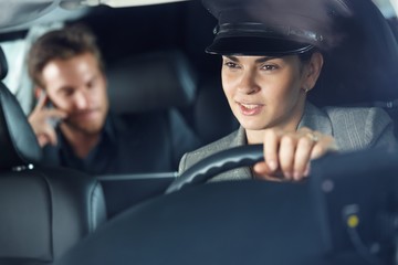 Female chauffeur driving a limousine