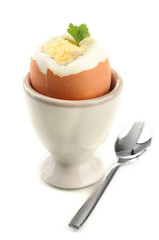 Boiled egg in egg cup, isolated on white