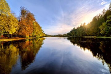 Fototapeta na wymiar Sunset on Lake in Autumn Forest