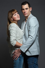 Young couple man and woman in love. Studio shot.