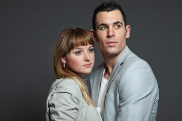 Young couple man and woman in love. Studio shot.