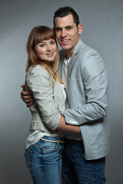 Young couple man and woman in love. Studio shot.