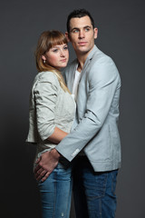 Young couple man and woman in love. Studio shot.