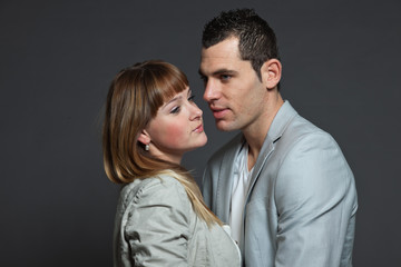 Young couple man and woman in love. Studio shot.
