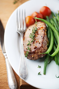 Rustic beef steak with herbs and vegetables