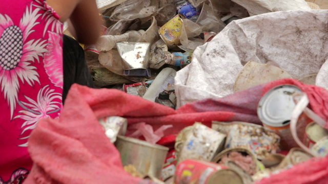 Garbage gatherers assorting trashes in slums