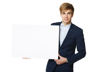 Young man in suit holding blank whiteboard