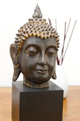 Buddha head and incense sticks
