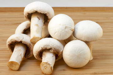 white champignons on a wooden board
