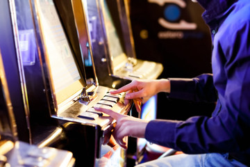 Man using an electronic slot machine
