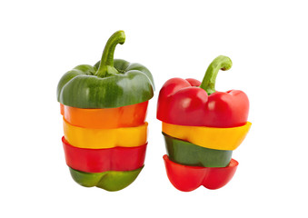 sliced fresh red, orange, yellow and green sweet peppers on a wh