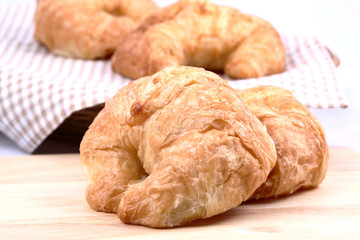 Fresh croissant on wood board