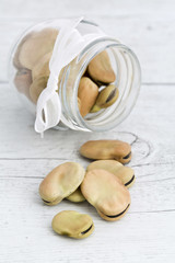 Beans in glass jar on wooden background
