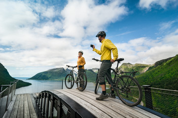 two cyclists relax biking