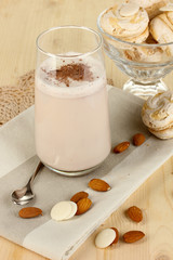 Glass of chocolate-cream cocktail on wooden table close-up