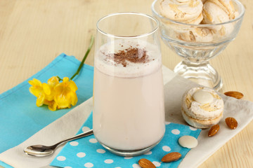 Glass of chocolate-cream cocktail on wooden table close-up