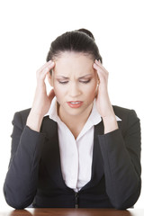 Sad businesswoman sitting behind the desk
