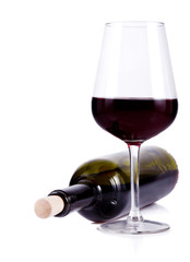 wine glass with red wine and lying bottle of wine