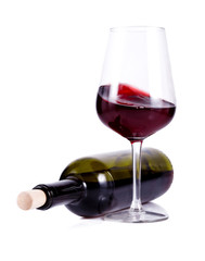 wine glass with red wine and lying bottle of wine