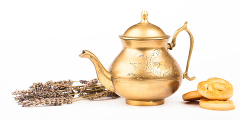 old brass teapot and sweet cookies isolated on white